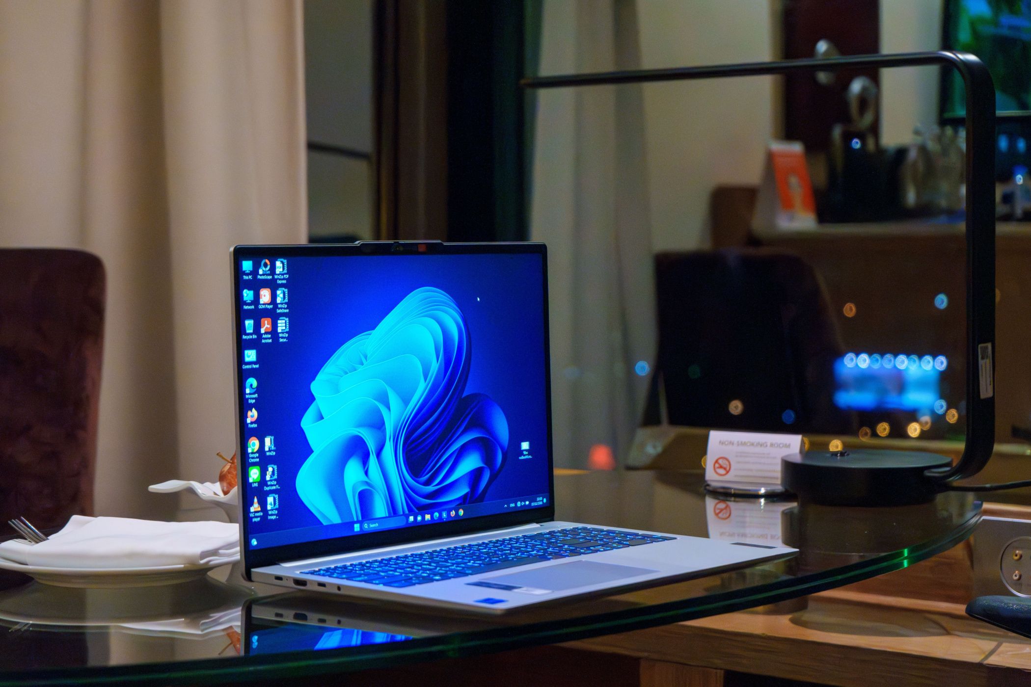 windows-laptop-on-glass-table-with-icons-on-desktop.jpg